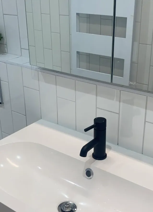 Matt black basin tap on a white vanity basin