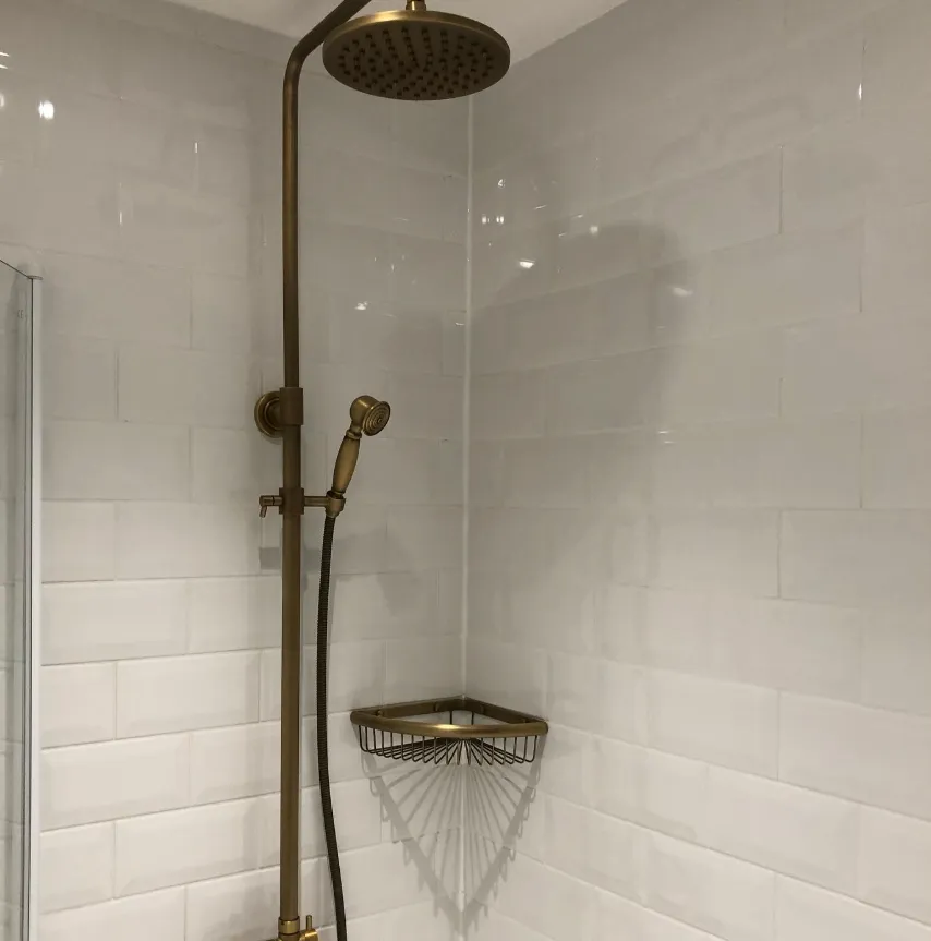 Brushed brass rainfall shower with white metro tiles
