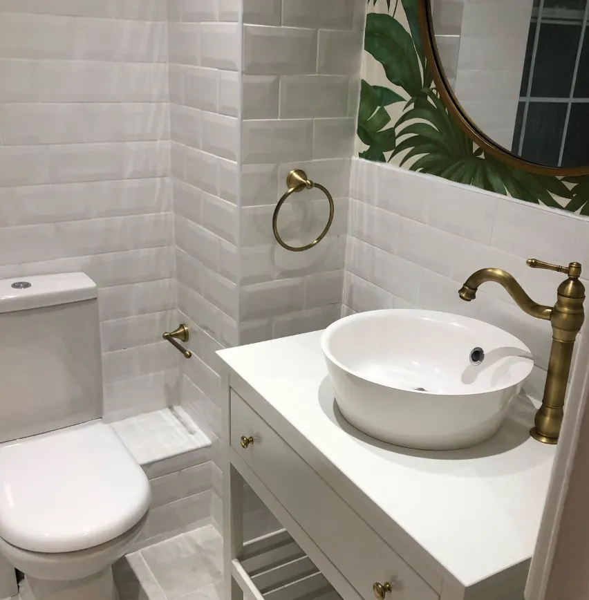 Brushed brass tap on a white vessel basin